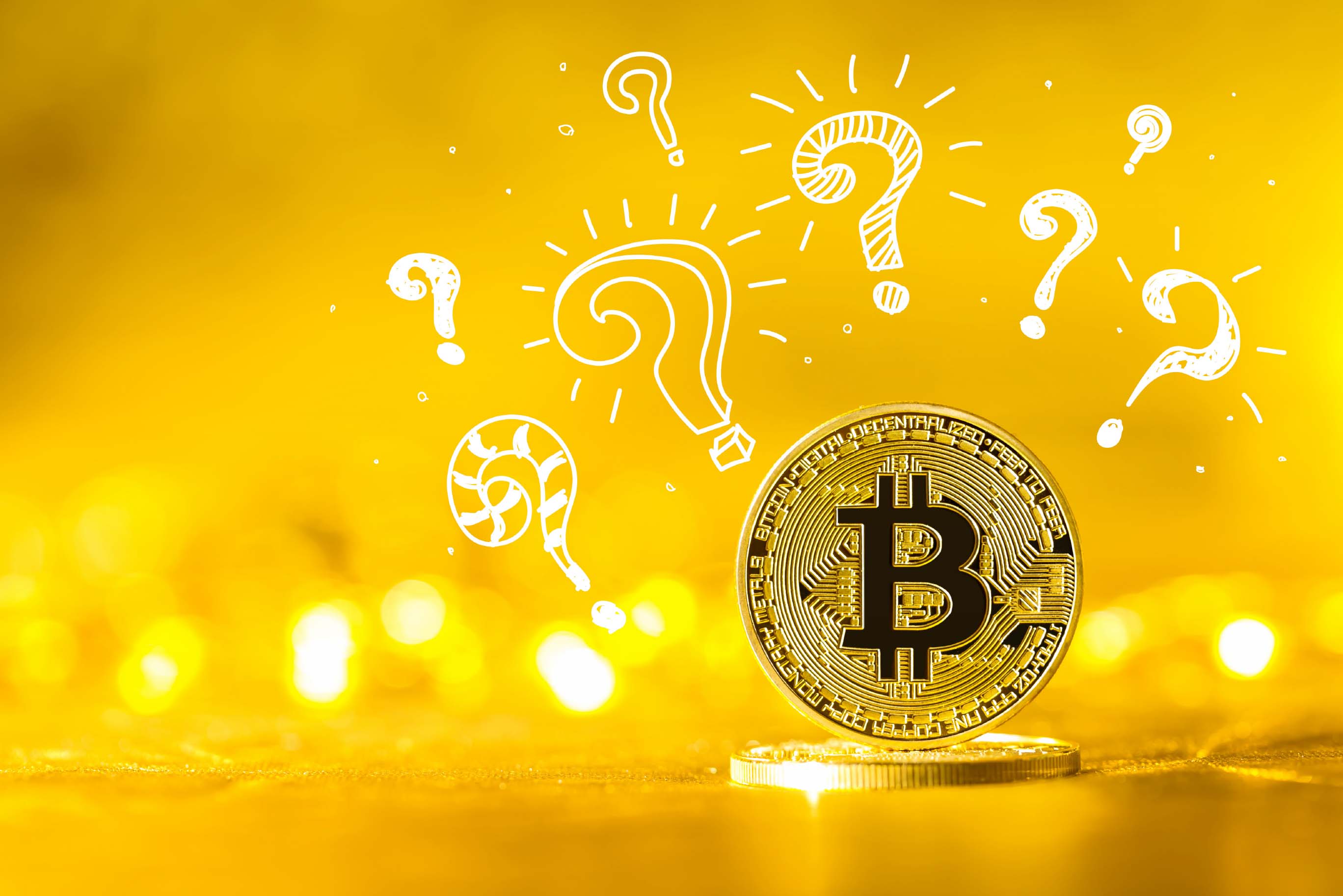 A gold-colored physical Bitcoin coin is balanced vertically on another surface against a bright, warm yellow background featuring bokeh light effects. Several white, sketched question marks of various sizes are superimposed above and behind the coin.